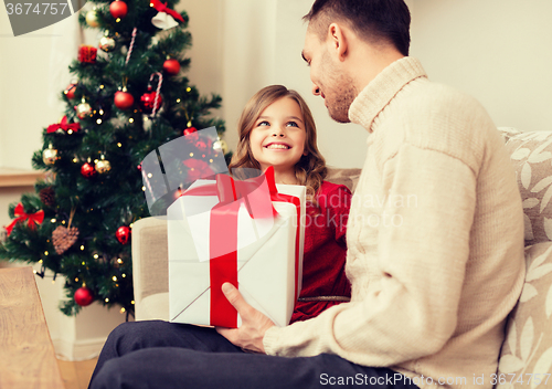 Image of smiling father and daughter looking at each other