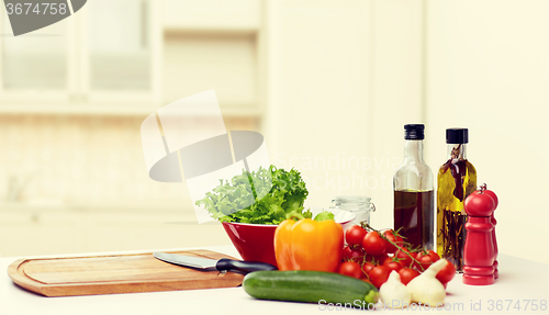 Image of vegetables, spices and kitchenware on table