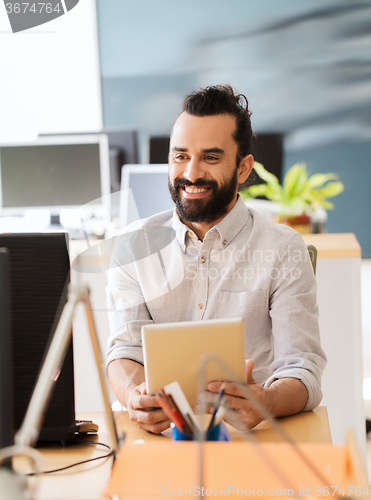 Image of happy creative male office worker with tablet pc