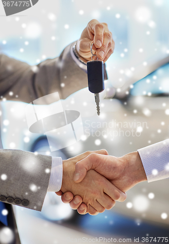 Image of close up of handshake in auto show or salon