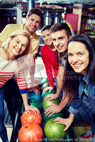 Image of happy friends in bowling club