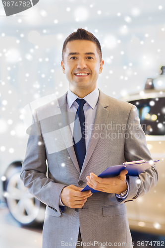 Image of happy man at auto show or car salon