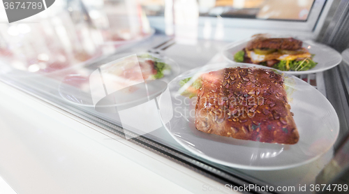 Image of close up of sandwich in cafe showcase or store