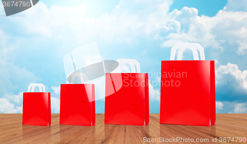 Image of many blank red shopping bags