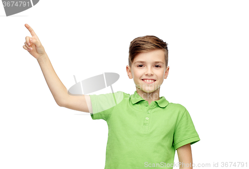 Image of happy boy in green polo t-shirt pointing finger up