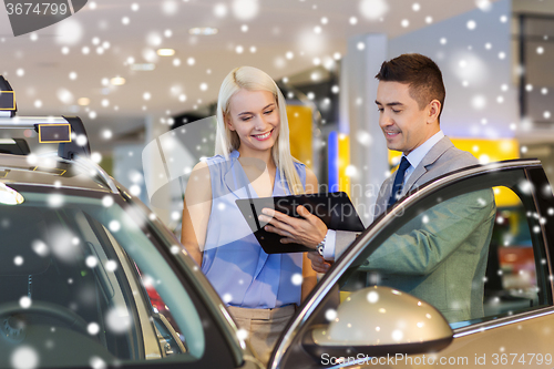 Image of happy woman with car dealer in auto show or salon