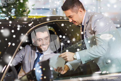 Image of happy man with car dealer in auto show or salon