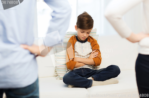 Image of upset or feeling guilty boy and parents at home