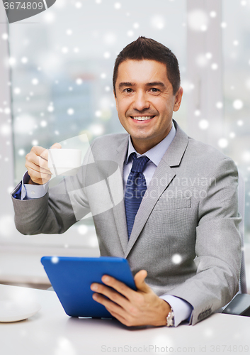 Image of smiling businessman with tablet pc and coffee cup