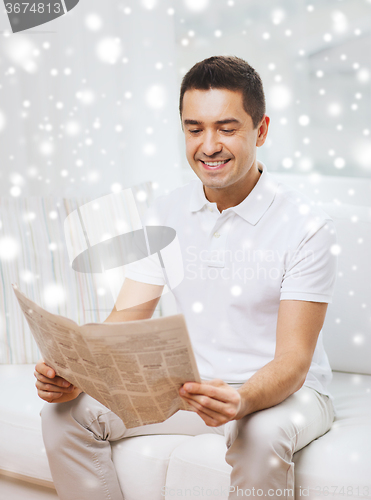 Image of happy man reading newspaper at home