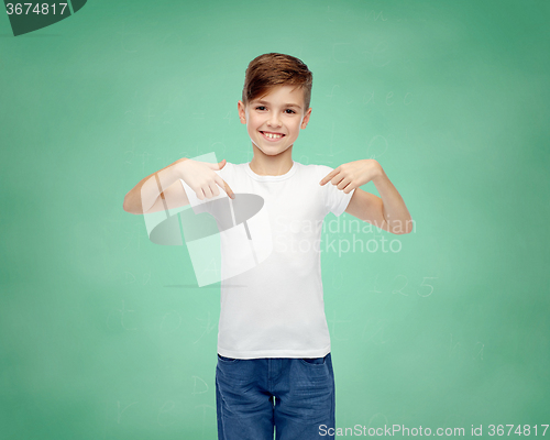 Image of happy boy pointing finger to his white t-shirt