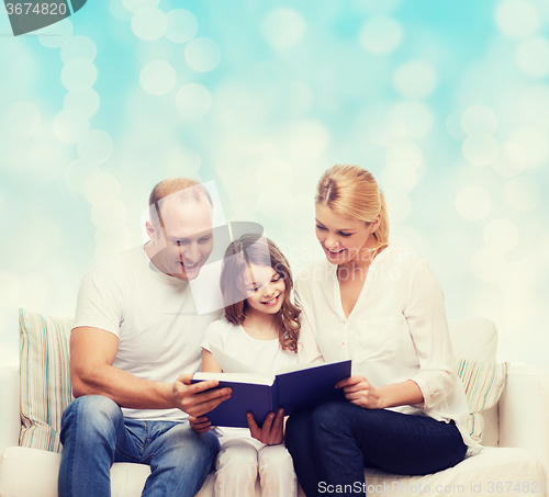 Image of happy family with book at home