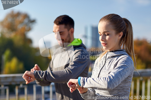 Image of couple running over city highway bridge