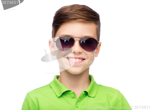 Image of smiling boy in sunglasses and green polo t-shirt