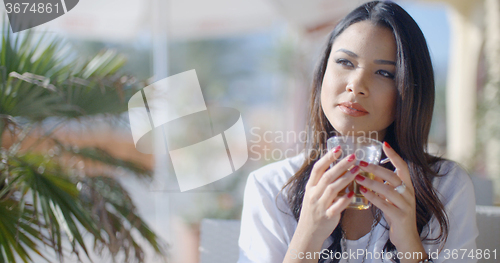 Image of Girl Sitting At Cafe With Cup Of Tea