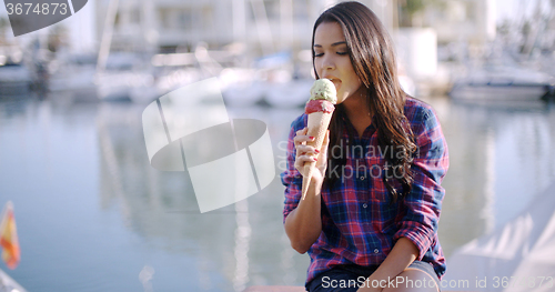Image of Woman Enjoying Ice Cream On Vacation