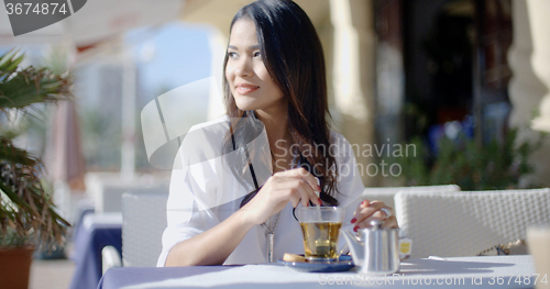 Image of Girl Sitting At Cafe With Cup Of Tea