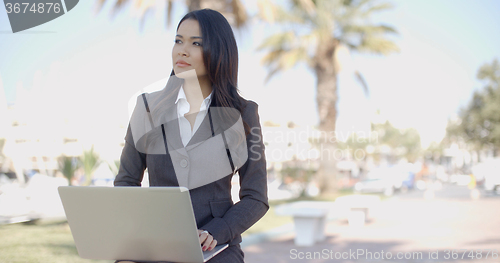 Image of Young Business Woman Working On A Laptop