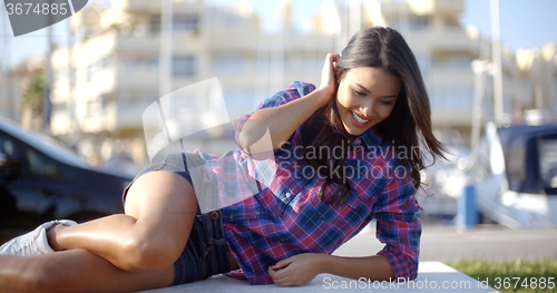 Image of Girl Lying On A Park Bench