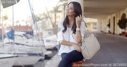 Image of Woman Relaxing On Bench In Yacht Port