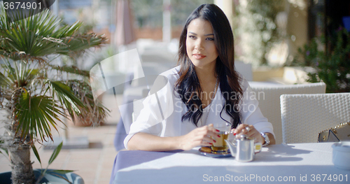 Image of Woman Waiting For Friend In Cafe