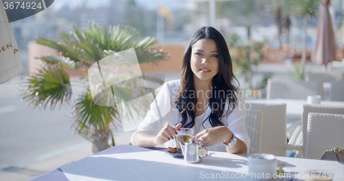 Image of Girl Sitting At Cafe With Cup Of Tea