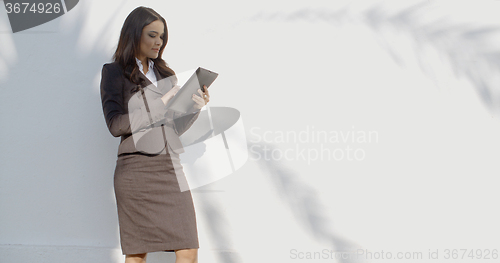 Image of Young Woman Using Tablet Outdoors