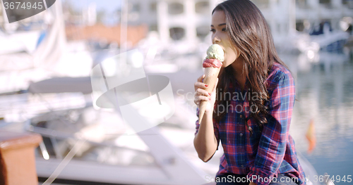 Image of Woman Enjoying Ice Cream On Vacation