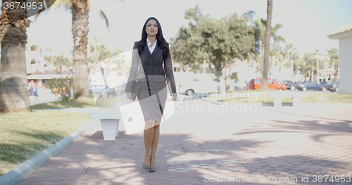 Image of Lady In A Suit Walking Down The Street