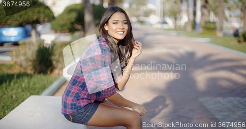 Image of Young Woman Sitting In A Summer Park
