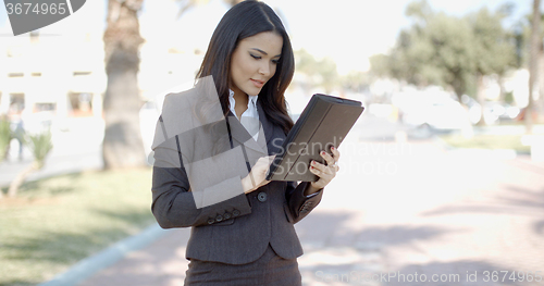 Image of Businesswoman Using Tablet Outdoors