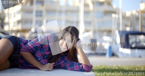 Image of Girl Lying On A Park Bench