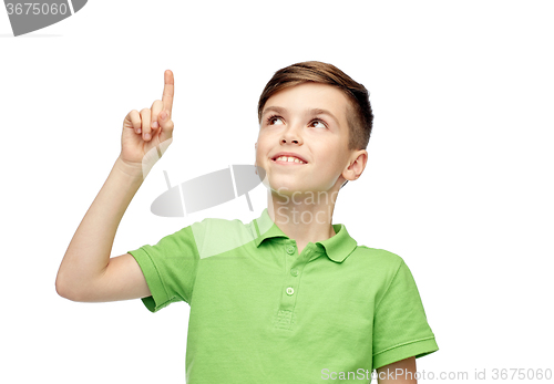 Image of happy boy in green polo t-shirt pointing finger up