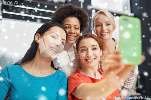 Image of happy young women taking selfie with smartphone
