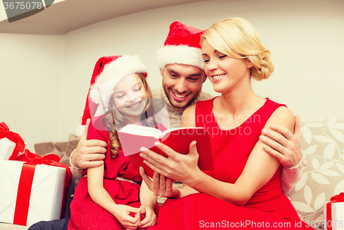 Image of smiling family reading book