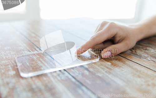 Image of close up of woman with transparent smartphone