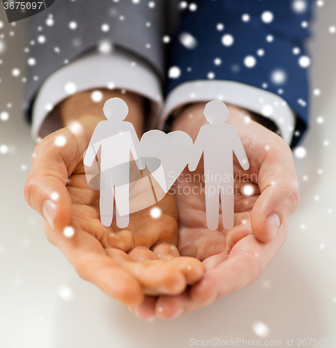 Image of close up of happy male gay couple with love symbol