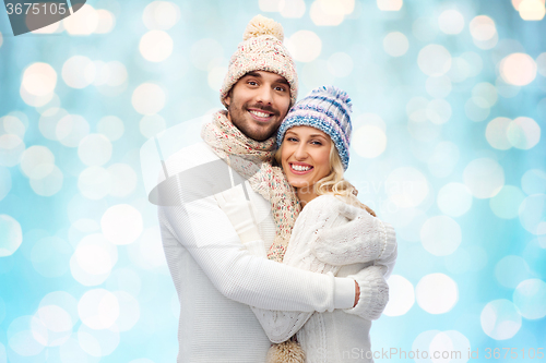 Image of smiling couple in winter clothes hugging