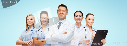 Image of group of smiling doctors with clipboard