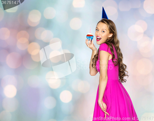 Image of happy woman or teen girl with birthday cupcake