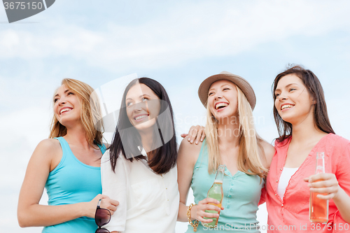 Image of girls with drinks on the beach