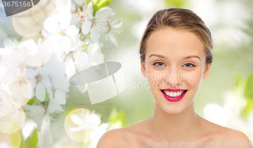 Image of smiling young woman face and shoulders