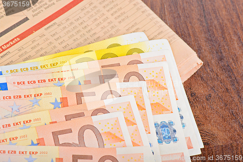 Image of Close-up of Euro banknotes with newspaper