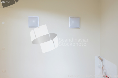 Image of White blank picture frames over white wall
