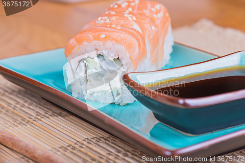 Image of California maki sushi with fish and soy sauce