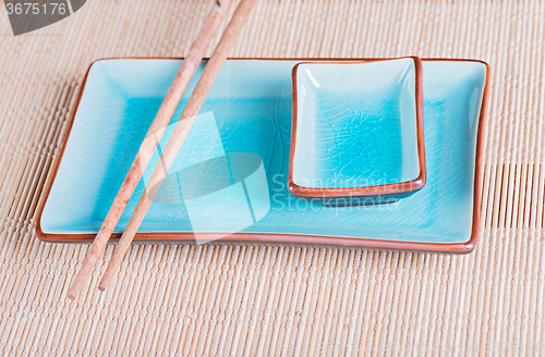 Image of View to bamboo mat, dish and chopsticks
