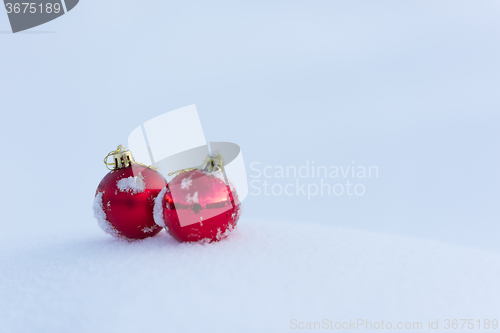 Image of red christmas balls in fresh snow