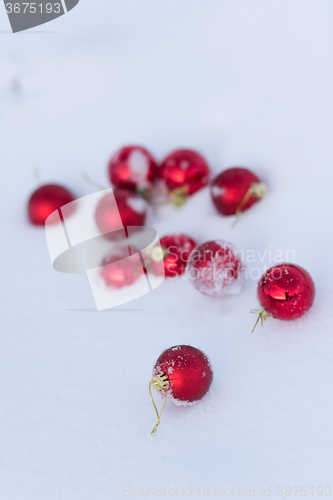 Image of red christmas balls in fresh snow