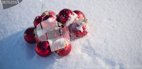 Image of red christmas ball in fresh snow