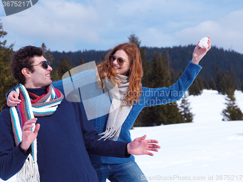 Image of happy young couple having fun on fresh show on winter vacation